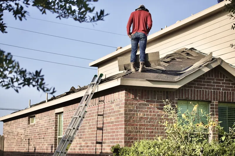 Professional roofer working on a residential roof in Shackelford Estates